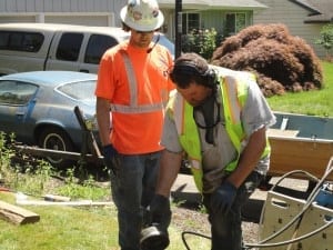 Directional drilling crew communicating with Sonetics Wireless Headsets during a sewer line replacement.