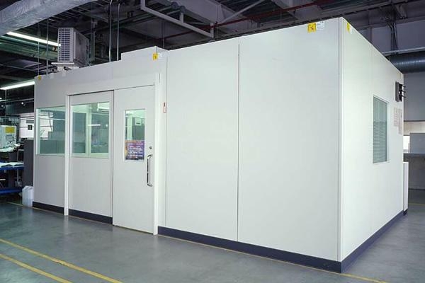 A factory office partition used as a quiet room inside a loud manufacturing facility.