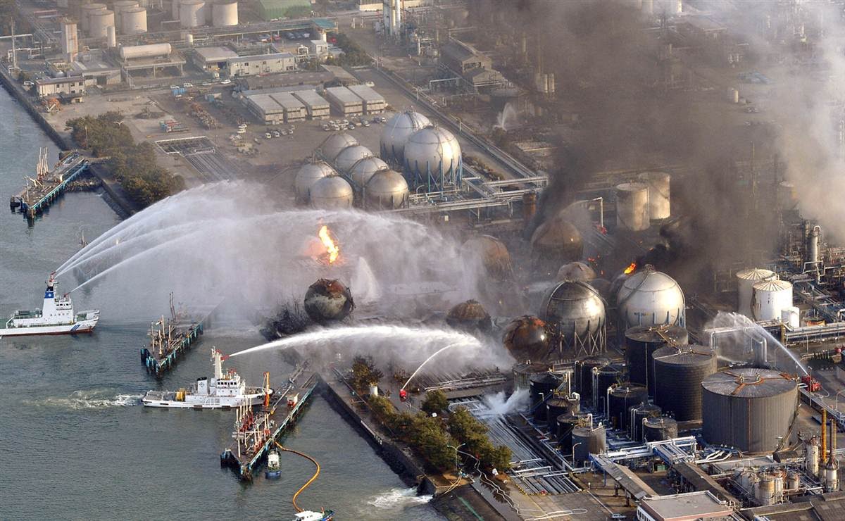 Boats spray water onto fires outside the Fukushima Daiichi nuclear power plant.
