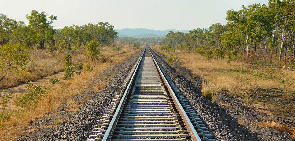 Railroad tracks extending to the horizon between Adelaide and Darwin in Australia.