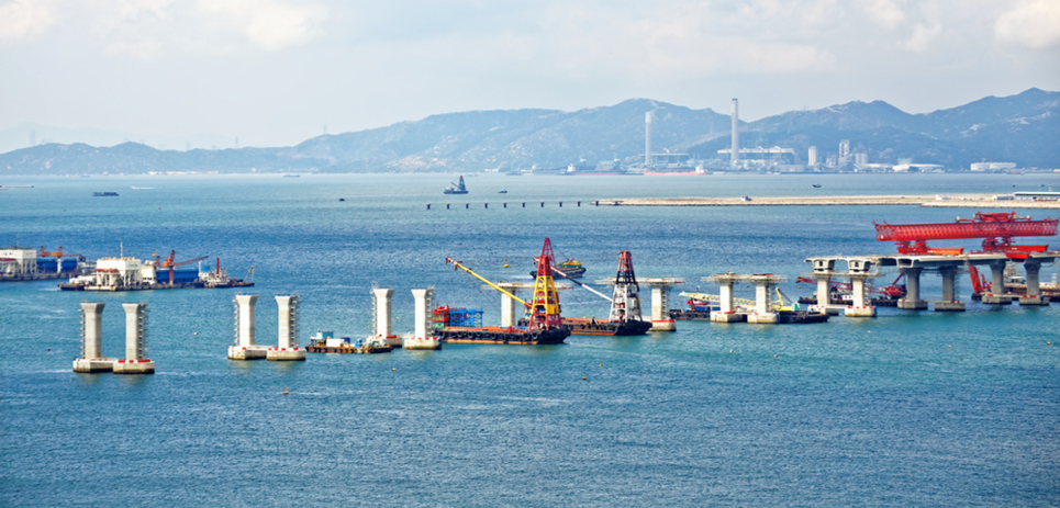 Boat-based cranes work to construct a bridge between Hong Kong, Zhuhai, and Macao.