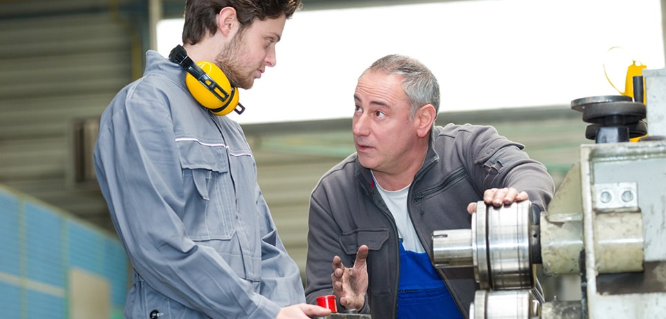 manufacturing instructor trains apprentice
