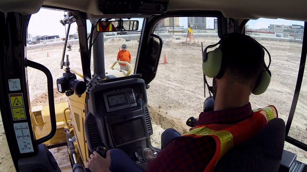 construction trainer and trainee use wireless headsets to maintain social distancing 