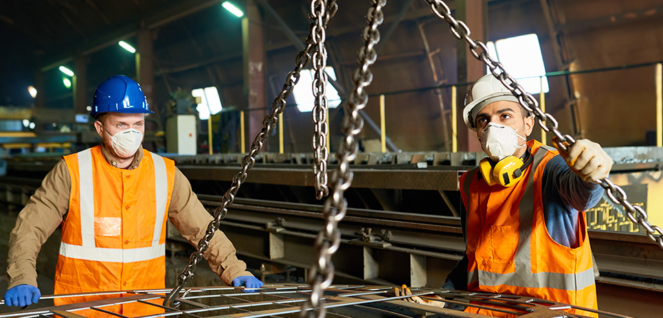 Steel workers wearing N95 masks on the factory floor.